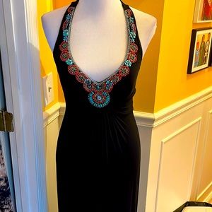 Long flowing black max halter dress, with southwestern style trim at neckline.
